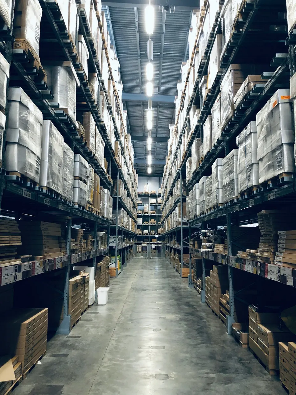 Tall warehouse aisle with racked inventory